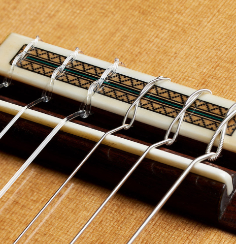 The bridge, tie-block and saddle of a 2024 Teodoro Perez "Especial" classical guitar with cedar and cocobolo