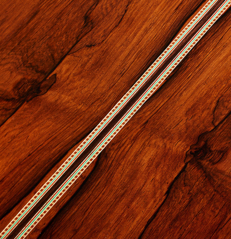 The back center seam of a 2024 Teodoro Perez "1884 Torres - La Emperatriz" classical guitar made of spruce and African rosewood
