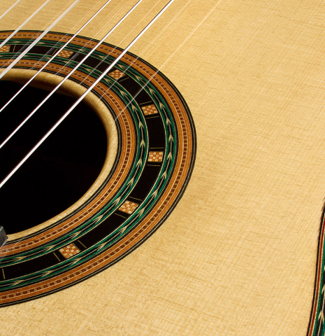 The soundboard and rosette detail of a 2025 Teodoro Perez "1884 Torres - La Emperatriz" classical guitar made of spruce and African rosewood