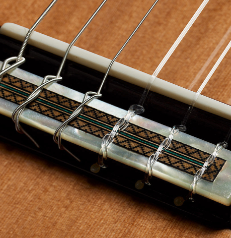 The bridge, tie-block and saddle of a 2025 Teodoro Perez "Especial" classical guitar with cedar and Indian rosewood