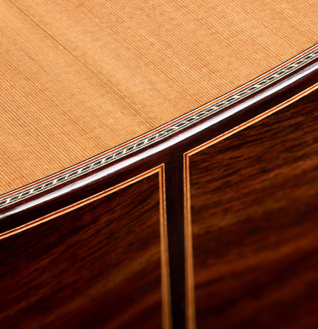 The top binding and purfling of a 2026 Sergio Perez "Segovia" classical guitar made of cedar and Indian rosewood
