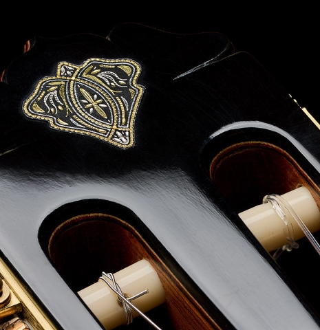 The headstock with inlay of a 2026 Teodoro Perez "60th Anniversary" classical guitar made of spruce and pau ferro