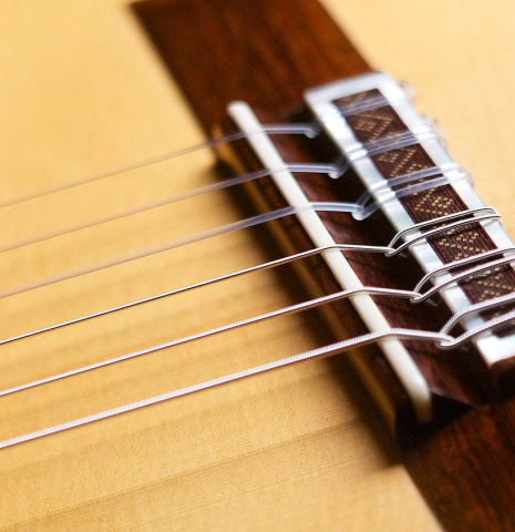 The bridge and saddle of a 2007 Jose Marin Plazuelo &quot;Bouchet&quot; classical guitar made with spruce and CSA rosewood