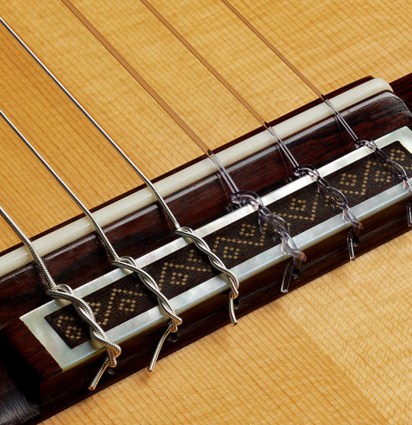 The bridge, tie-block and saddle of a 2021 Jose Marin Plazuelo "Bouchet" classical guitar made with spruce and CSA rosewood