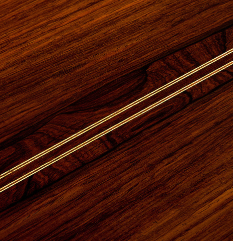 The back center seam of a 1999 Jose Marin Plazuelo "Bouchet" classical guitar made of spruce and CSA rosewood