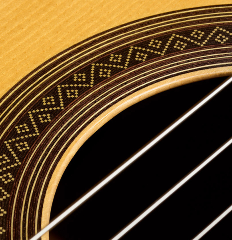 The top and rosette of a 1999 Jose Marin Plazuelo "Bouchet" classical guitar made of spruce and CSA rosewood