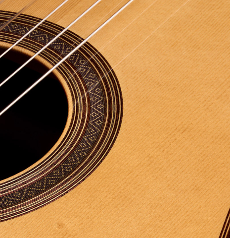 The soundboard and rosette of a 2005 Jose Marin Plazuelo "Bouchet" classical guitar made of spruce and CSA rosewood