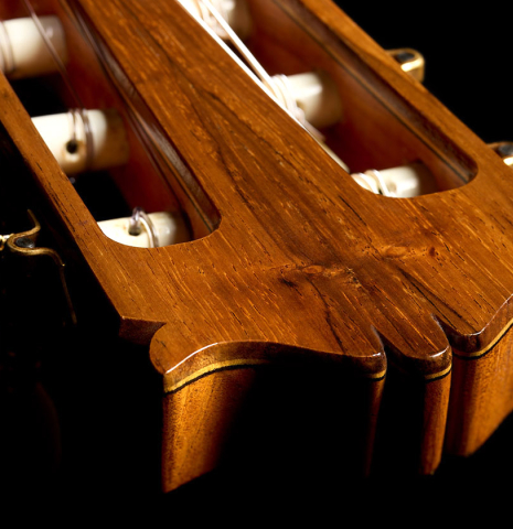 The carved head and tuning machines of a 1987 Richard Prenkert classical guitar made of spruce and CSA rosewood