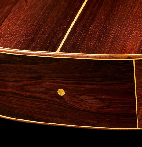 The back and sides at the foot of a 2024 Jake Fuller "Purnell" classical guitar made of spruce and CSA rosewood