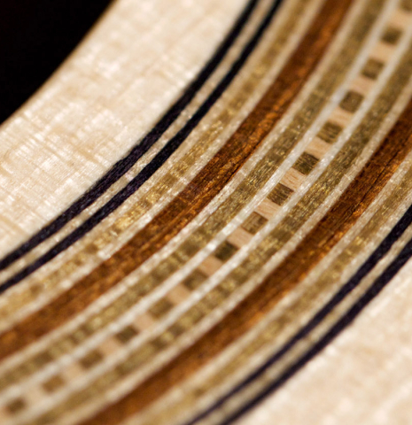 A close-up of the rosette of a a 2022 Jake Fuller "Purnell" classical guitar made of spruce and Honduran rosewood