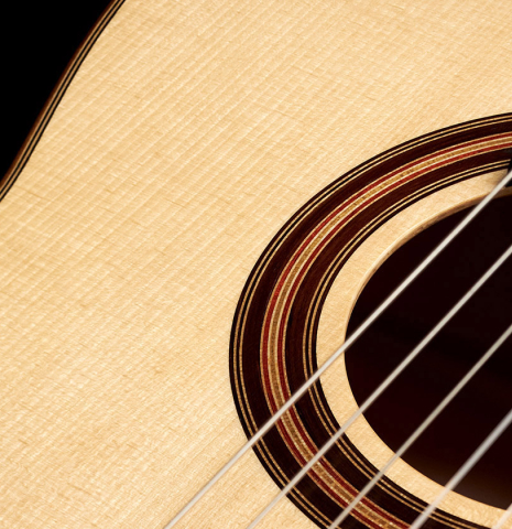 The soundboard of a 2023 Jake Fuller "Purnell" classical guitar made with spruce and maple.