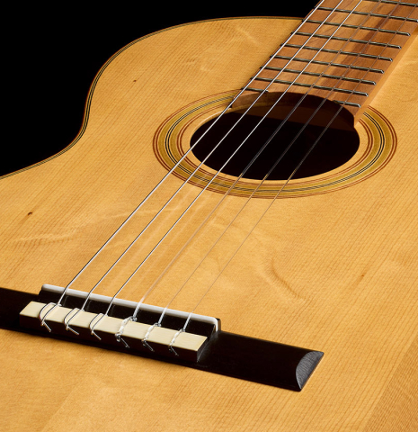 The soundboard of a 2023 Jake Fuller "Purnell" w/pegs "Torres" classical guitar made of spruce and tulipwood