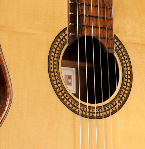 The rosette and soundboard of a 2009 Fabio Ragghianti classical guitar made of spruce and CSA rosewood