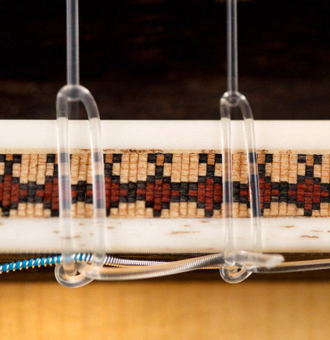 The bridge of a 2009 Fabio Ragghianti classical guitar made of spruce and CSA rosewood