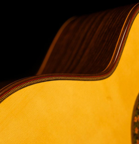 This is a side-view of a Jose Ramirez "130 Anos" classical guitar built in 2014. It has a spruce soundboard and Indian rosewood back and sides.