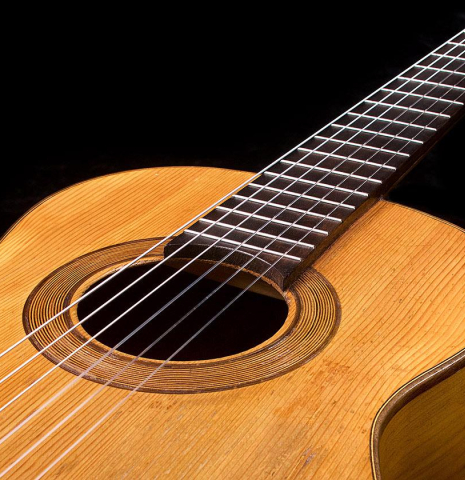 The nylon strings and soundboard of a 1945 Jose Ramirez II classical guitar made of spruce and cypress