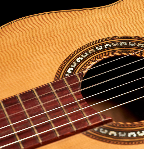 The fretboard and rosette of a 1900's Manuel Ramirez &quot;Santos&quot; vintage classical guitar made of spruce and mahogany