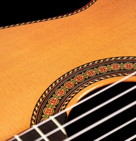 The soundboard and rosette of a 2003 Jose Ramirez &quot;Centenario&quot; classical guitar made of cedar and CSA rosewood
