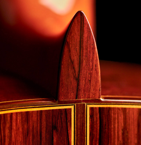The heel of a 2007 Jose Ramirez "1a C650-AP" classical guitar made of spruce and CSA rosewood.