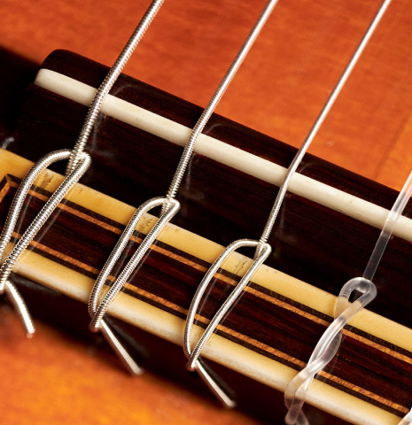 The bridge, tie-block and saddle of a 1964 Jose Ramirez "1a AM" SP/CSAR classical guitar made by Mariano Tezanos with spruce top and CSA rosewood.