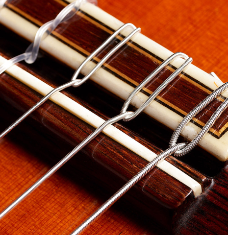 The bridge, tie-block and saddle of a 1977 Jose Ramirez "1a" classical guitar made with cedar and Indian rosewood.