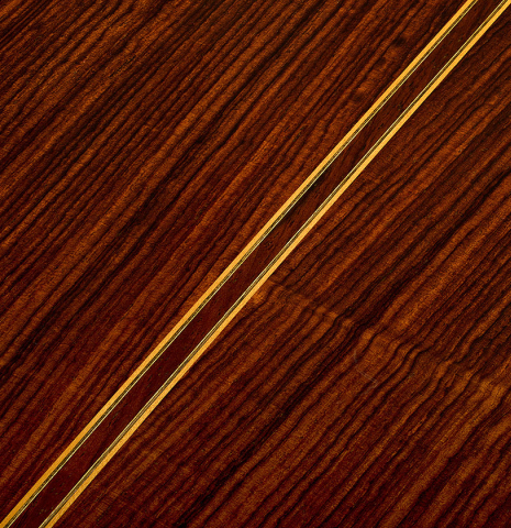 The back center seam and purfling of a 2004 Jose Ramirez "1a Tradicional" classical guitar made of spruce and Indian rosewood