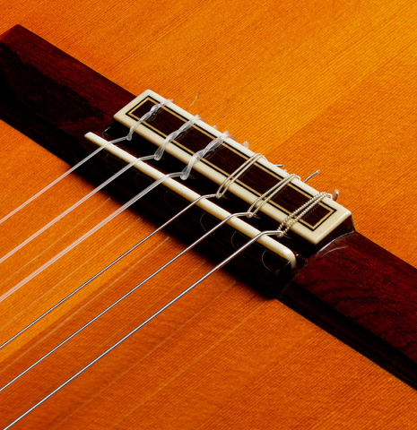 The bridge, tie-block and saddle of a 1973 Jose Ramirez "2a" Spanish classical guitar made with cedar top and CSA rosewood back and sides.