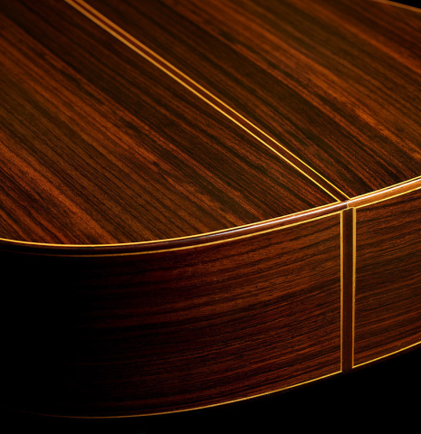 The sides at the foot of a 2013 Jose Ramirez "1a Antigua" classical guitar made of spruce and Indian rosewood