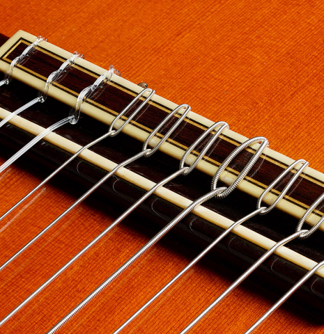 The bridge, tie-block and saddle of a 1973 Jose Ramirez "1a 10-String" classical guitar made of cedar and CSA rosewood