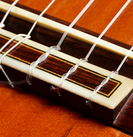 The bridge, tie-block and saddle of a 1970 Jose Ramirez "1a" classical Spanish guitar made with cedar and CSA rosewood.