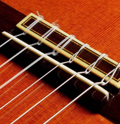 The bridge, tie-block and saddle of a 1977 Jose Ramirez "1a" classical guitar made of cedar and Indian rosewood