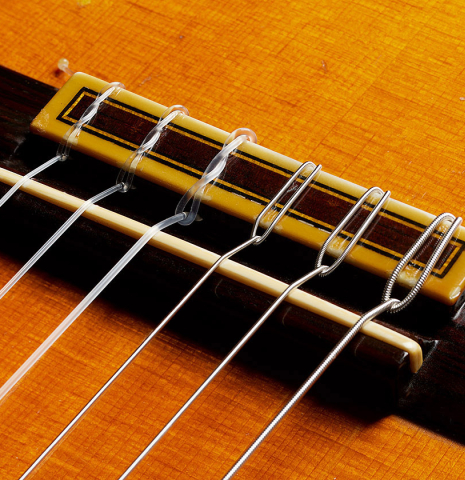 The bridge, tie-block and saddle of a 1963 Jose Ramirez "1a AM" classical guitar made of spruce and CSA rosewood by Antonio Martinez.