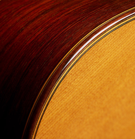 The top binding and purfling of a 2004 Jose Ramirez "1a Tradicional" classical guitar made of cedar and Indian rosewood