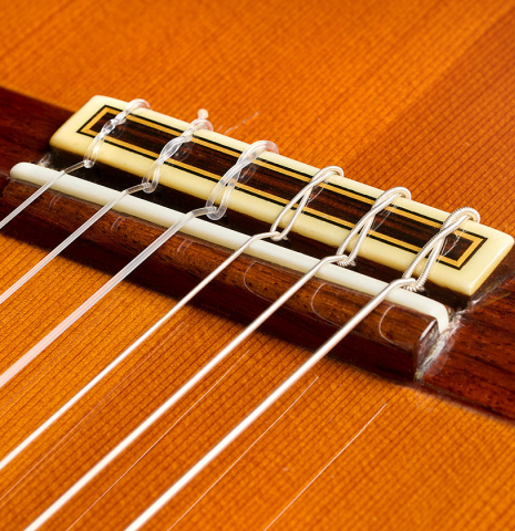 The bridge, tie-block and saddle of a 1985 Jose Ramirez "1a" classical guitar made of cedar and Indian rosewood