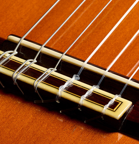 The bridge, tie-block and saddle of a 1969 Jose Ramirez "1a MT" classical guitar made of cedar and CSA rosewood
