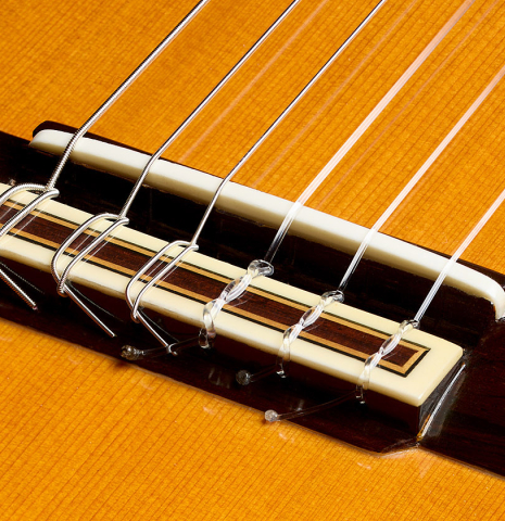 The bridge, tie-block and saddle of a 2007 Jose Ramirez "Elite" classical guitar made of cedar and African rosewood