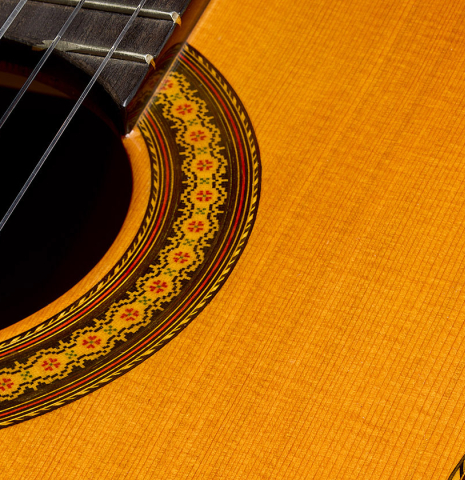 The soundboard and rosette of a 2007 Jose Ramirez "Elite" classical guitar made of cedar and African rosewood