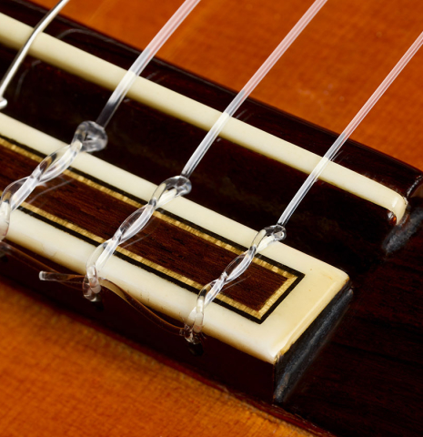 The bridge, tie-block and saddle of a 1979 Jose Ramirez "1a" classical guitar made of cedar and Indian rosewood