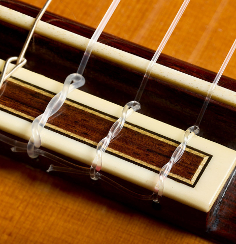The bridge, tie-block and saddle of a 1979 Jose Ramirez "1a" classical guitar made of cedar and Indian rosewood