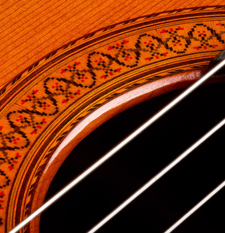 The soundhole and rosette of a 1975 Jose Ramirez "1a" classical guitar made of cedar and Indian rosewood