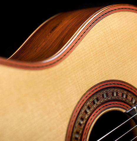 The soundboard, rosette, and side of a 2010 John Ray "Torres" classical guitar made with spruce and CSA rosewood