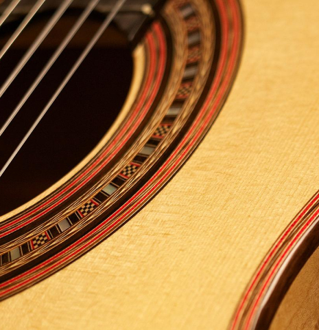 Close-up detail of the rosette of a 2012 John Ray "1892 Torres" classical guitar made of spruce and maple