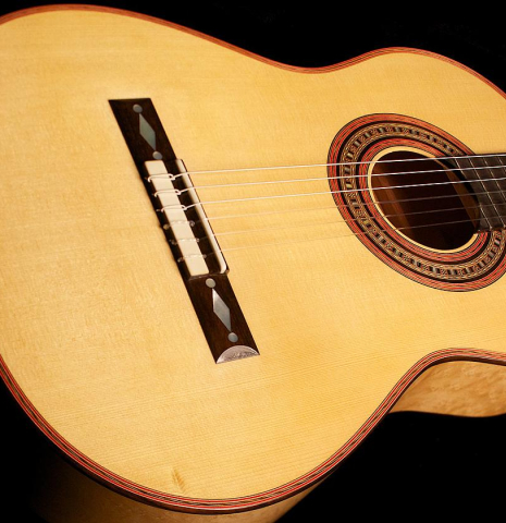 The top and sides of a 2012 John Ray "1892 Torres" classical guitar made of spruce and maple