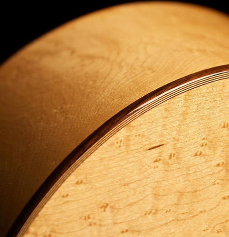 The back binding and purfling of a 2012 John Ray "1892 Torres" classical guitar made of spruce and maple