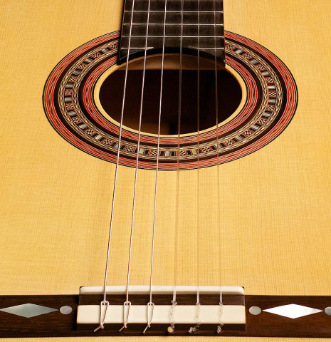 View of the soundboard from the bridge of a 2012 John Ray "1892 Torres" classical guitar made of spruce and maple