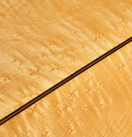 The back center seam of a 2012 John Ray "1892 Torres" classical guitar made of spruce and maple
