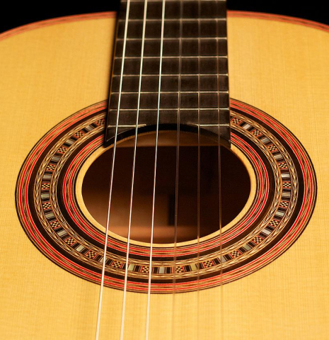 The rosette and fingerboard of a 2012 John Ray "1892 Torres" classical guitar made of spruce and maple