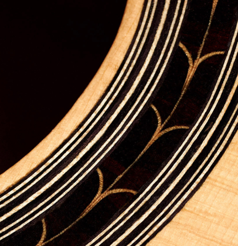 A close-up of the rosette of a 2003 Antonio Raya Pardo classical guitar made of spruce and CSA rosewood