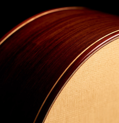 The side, soundboard and binding of a 2003 Antonio Raya Pardo classical guitar made of spruce and CSA rosewood