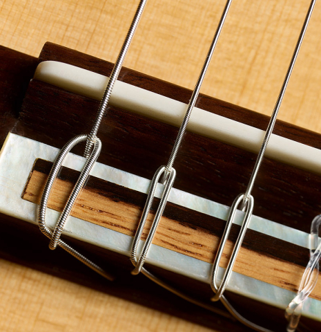 The bridge, tie-block and saddle of a 2017 Antonio Raya Pardo "Especial Torres" classical guitar made of spruce and CSA rosewood